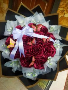 Buket bunga pita satin mewah berwarna merah yang estetik, kado everlasting love yang sedang tren di Bali untuk acara wisuda dan anniversary.